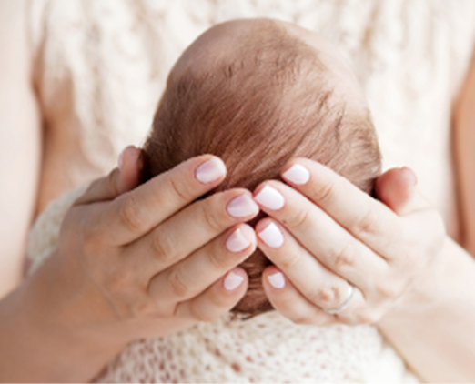 mother holding baby engaging in holistic sleep consultant